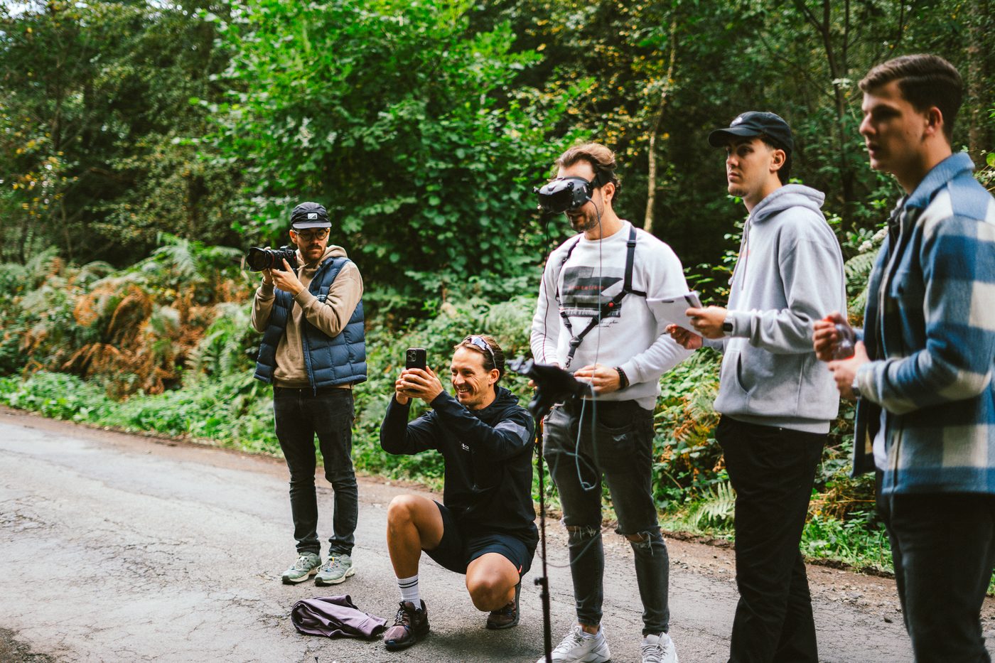Loek filming on a phone next to the full production crew